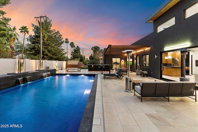 pool at dusk with an outdoor living space, a fenced in pool, a fenced backyard, and a patio area