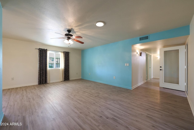 spare room with ceiling fan and light hardwood / wood-style flooring