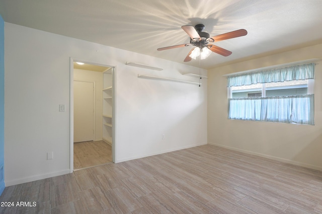 empty room featuring ceiling fan and light hardwood / wood-style flooring