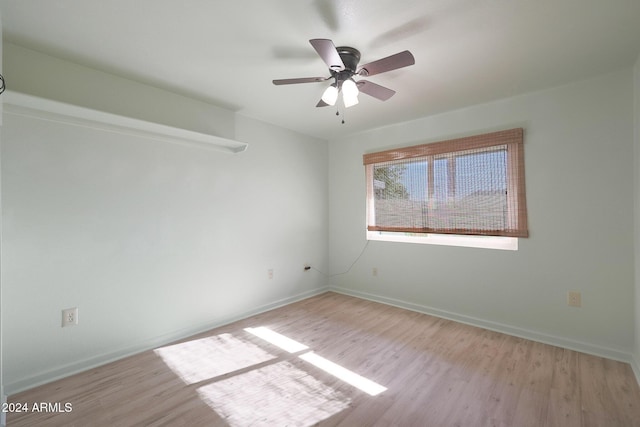 spare room with light wood-type flooring and ceiling fan