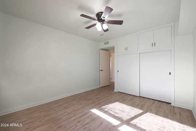 unfurnished bedroom featuring a closet, ceiling fan, and light hardwood / wood-style flooring