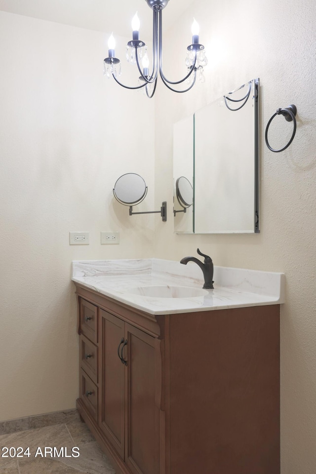 bathroom with tile patterned flooring, vanity, and a notable chandelier