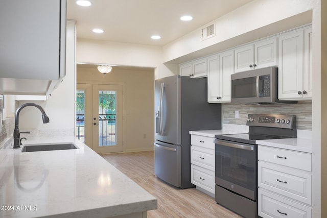 kitchen with sink, white cabinets, stainless steel appliances, and french doors