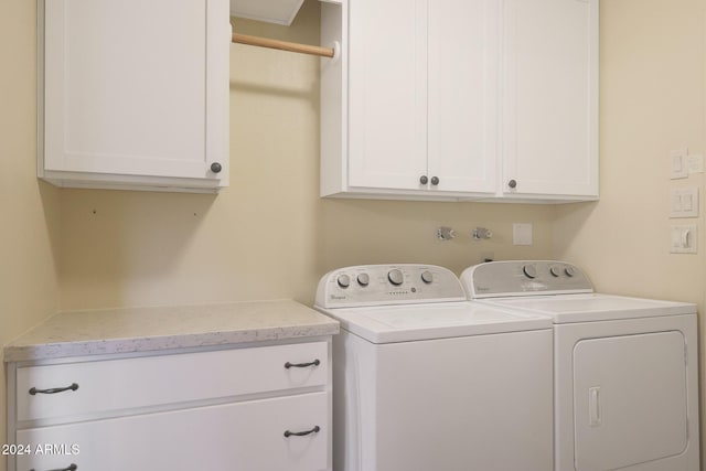 washroom featuring cabinets and washer and dryer