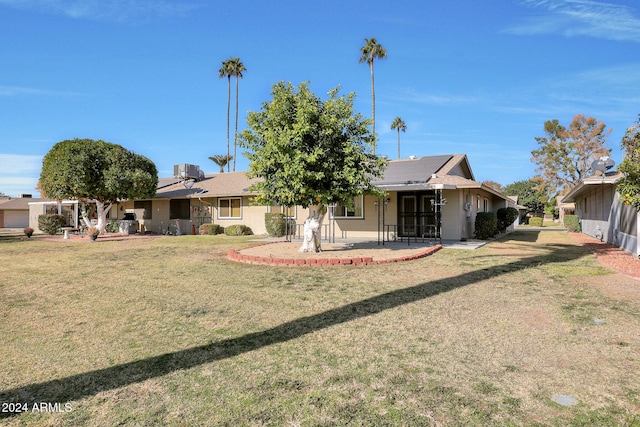 back of property featuring a yard