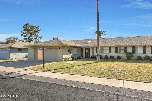 single story home with a front lawn and a garage