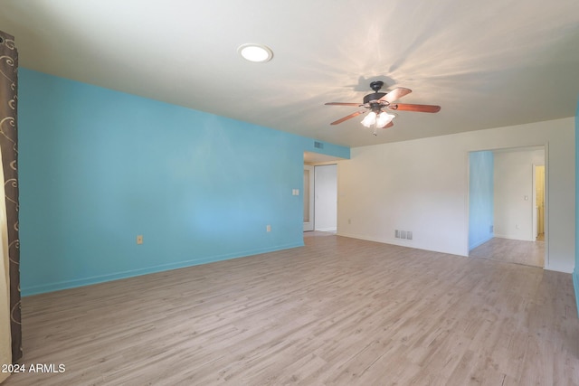 spare room featuring ceiling fan and light hardwood / wood-style floors