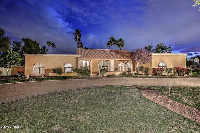 10365 E Paradise Dr, Scottsdale, AZ 85260 - mediterranean / spanish-style house with a front yard, a tiled roof, and stucco siding