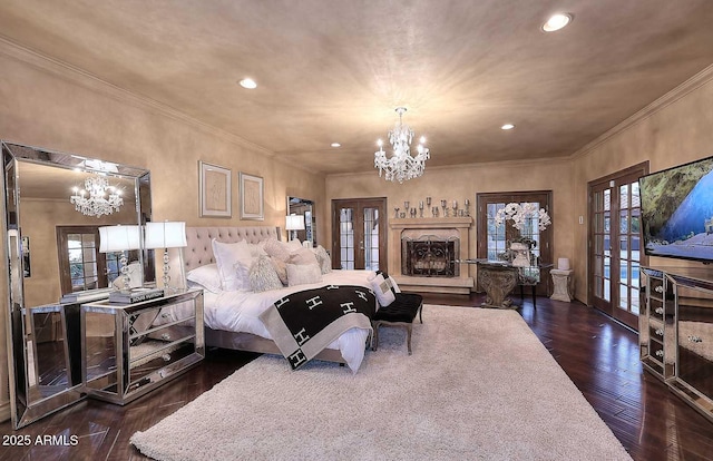 10365 E Paradise Dr, Scottsdale, AZ 85260 - bedroom featuring french doors, a chandelier, dark wood finished floors, and ornamental molding