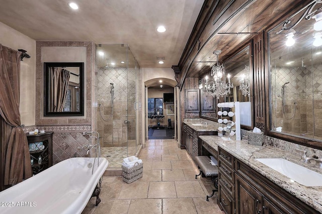 10365 E Paradise Dr, Scottsdale, AZ 85260 - full bathroom featuring a stall shower, stone tile flooring, tile walls, a freestanding bath, and vanity