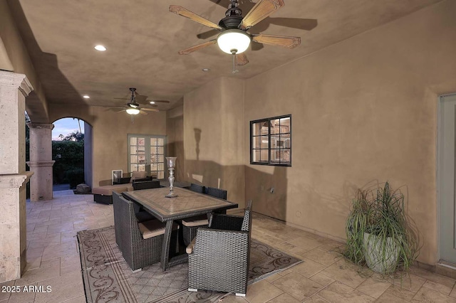 10365 E Paradise Dr, Scottsdale, AZ 85260 - dining room with a ceiling fan, decorative columns, recessed lighting, arched walkways, and stone tile flooring