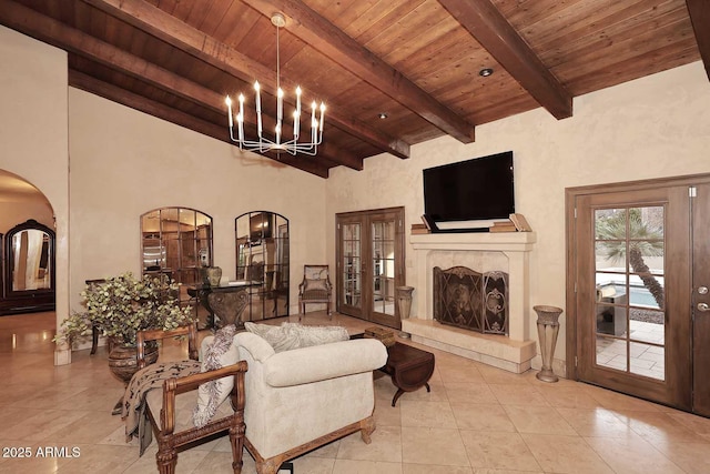 10365 E Paradise Dr, Scottsdale, AZ 85260 - living area with arched walkways, wood ceiling, french doors, beamed ceiling, and a notable chandelier