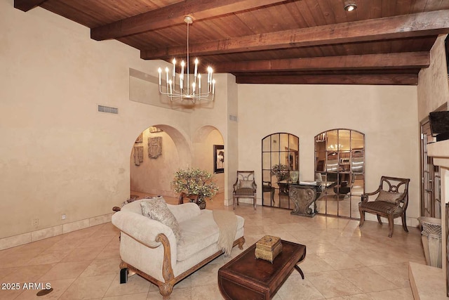 10365 E Paradise Dr, Scottsdale, AZ 85260 - living area featuring visible vents, beamed ceiling, wood ceiling, arched walkways, and a notable chandelier