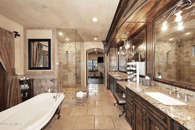 10365 E Paradise Dr, Scottsdale, AZ 85260 - full bath with vanity, stone tile floors, a stall shower, a soaking tub, and tile walls