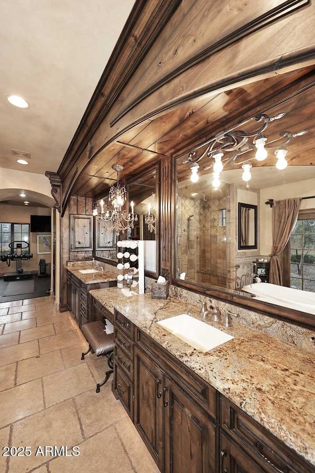 10365 E Paradise Dr, Scottsdale, AZ 85260 - full bath with vanity, stone tile floors, visible vents, recessed lighting, and a shower with door