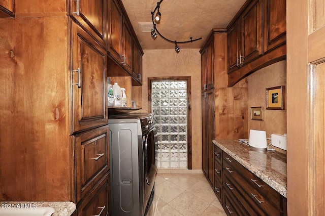 10365 E Paradise Dr, Scottsdale, AZ 85260 - clothes washing area featuring light tile patterned floors, washer / clothes dryer, cabinet space, and rail lighting