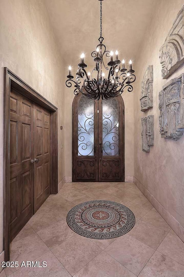 10365 E Paradise Dr, Scottsdale, AZ 85260 - foyer entrance with baseboards, a notable chandelier, lofted ceiling, and arched walkways