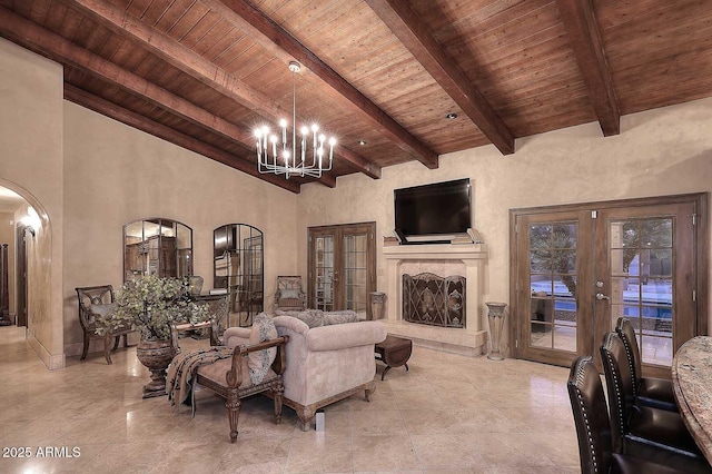 10365 E Paradise Dr, Scottsdale, AZ 85260 - living area with beamed ceiling, french doors, wooden ceiling, arched walkways, and a notable chandelier
