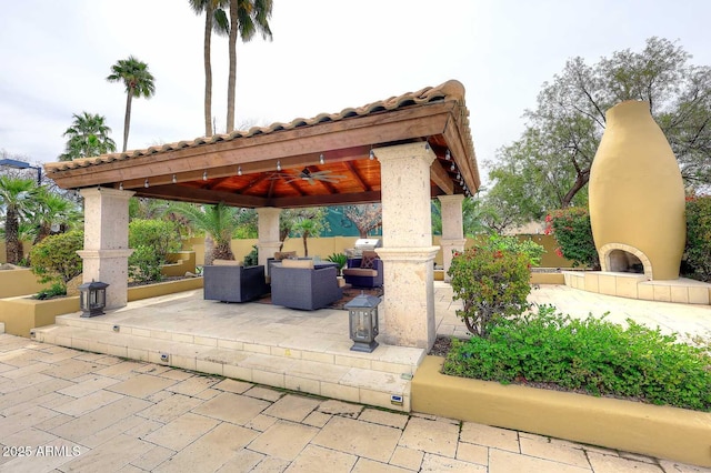 10365 E Paradise Dr, Scottsdale, AZ 85260 - view of patio featuring a gazebo, an outdoor living space with a fireplace, a ceiling fan, and fence