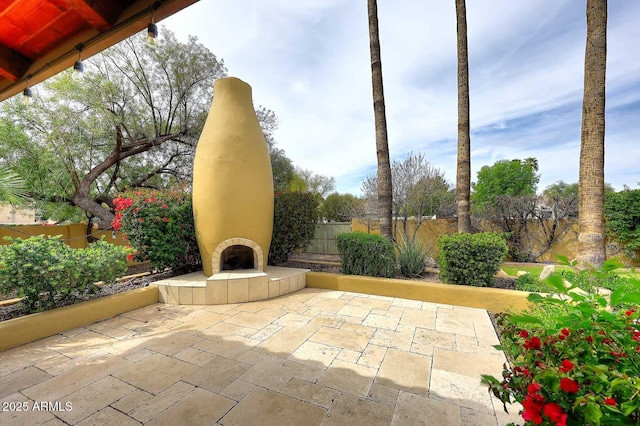 10365 E Paradise Dr, Scottsdale, AZ 85260 - view of patio / terrace with a fenced backyard and a tiled fireplace