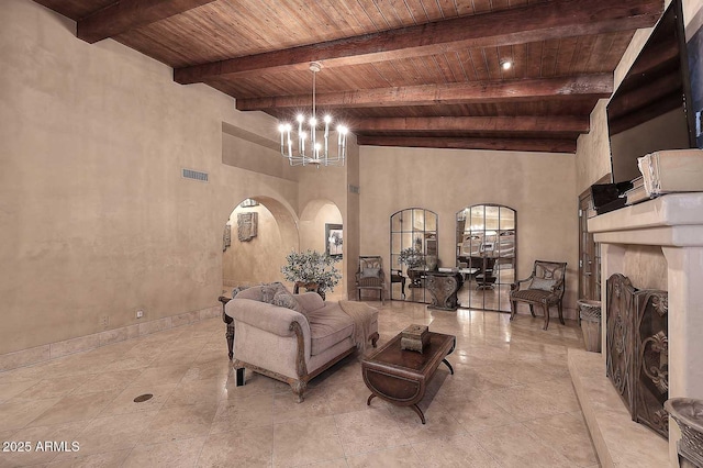 10365 E Paradise Dr, Scottsdale, AZ 85260 - living area with visible vents, beam ceiling, wooden ceiling, arched walkways, and a notable chandelier