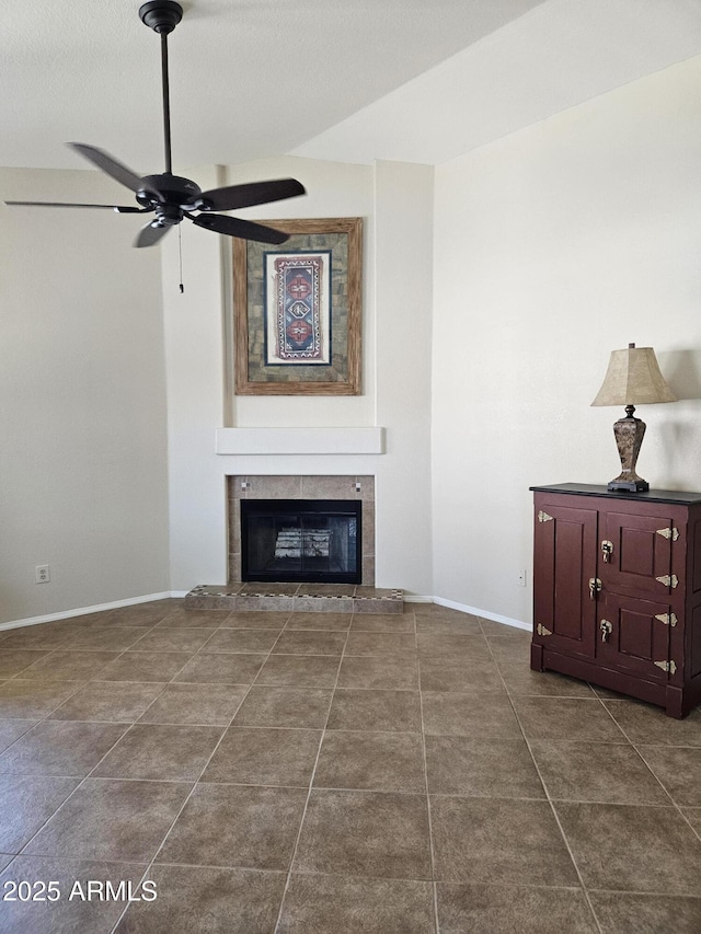 7724 W Topeka Dr W, Glendale, AZ 85308 - unfurnished living room with ceiling fan, a tile fireplace, baseboards, and dark tile patterned floors