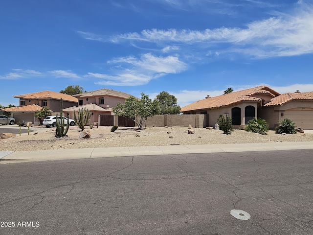 7724 W Topeka Dr W, Glendale, AZ 85308 - mediterranean / spanish-style home featuring a garage, stucco siding, a tile roof, and driveway