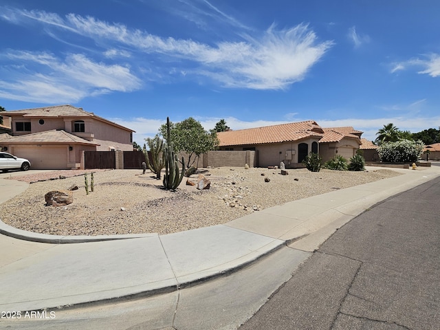 7724 W Topeka Dr W, Glendale, AZ 85308 - mediterranean / spanish-style house featuring driveway, stucco siding, a tile roof, and a garage