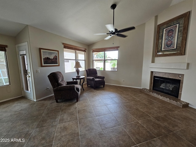 7724 W Topeka Dr W, Glendale, AZ 85308 - living area with vaulted ceiling, baseboards, a ceiling fan, a fireplace, and dark tile patterned floors