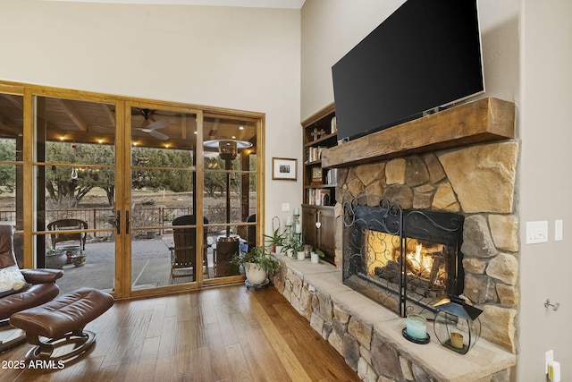 living room featuring a fireplace, hardwood / wood-style floors, and a wealth of natural light