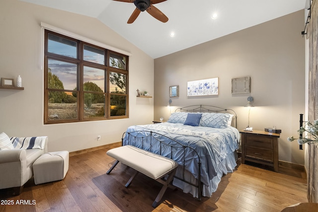 bedroom featuring ceiling fan, lofted ceiling, and light hardwood / wood-style floors