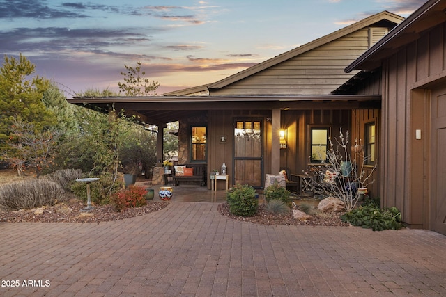 exterior entry at dusk with a patio