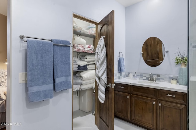 bathroom with tasteful backsplash and vanity