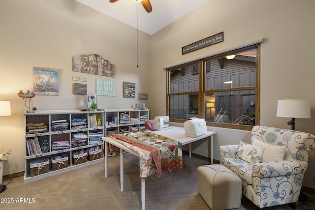 sitting room featuring ceiling fan and carpet floors