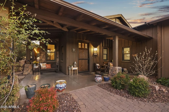 exterior entry at dusk featuring a patio area