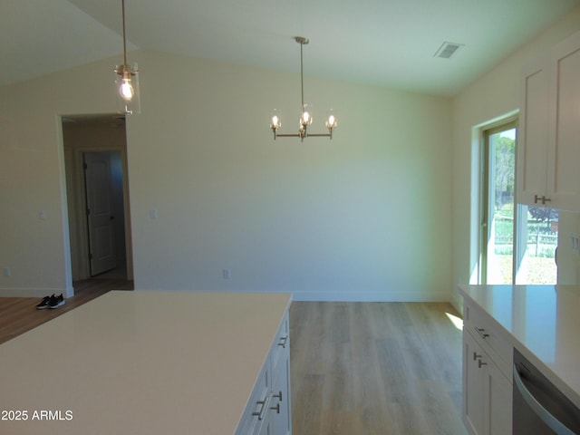 17707 E Jackrabbit Rd, Mayer, AZ 86333 - unfurnished dining area with light wood finished floors, a chandelier, baseboards, and vaulted ceiling