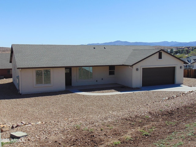 17707 E Jackrabbit Rd, Mayer, AZ 86333 - ranch-style home featuring a mountain view, an attached garage, a shingled roof, and driveway