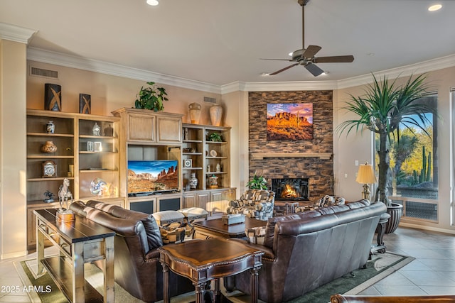 living room with ceiling fan, light tile patterned floors, a fireplace, and ornamental molding