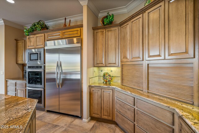 kitchen featuring built in appliances, light stone counters, and ornamental molding