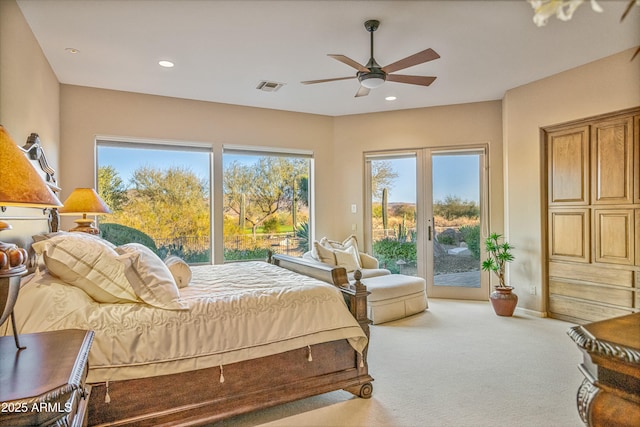 bedroom with ceiling fan, light colored carpet, and access to outside