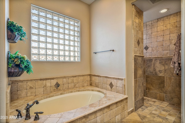 bathroom with shower with separate bathtub