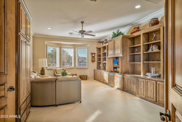 living room featuring light carpet, ceiling fan, and ornamental molding