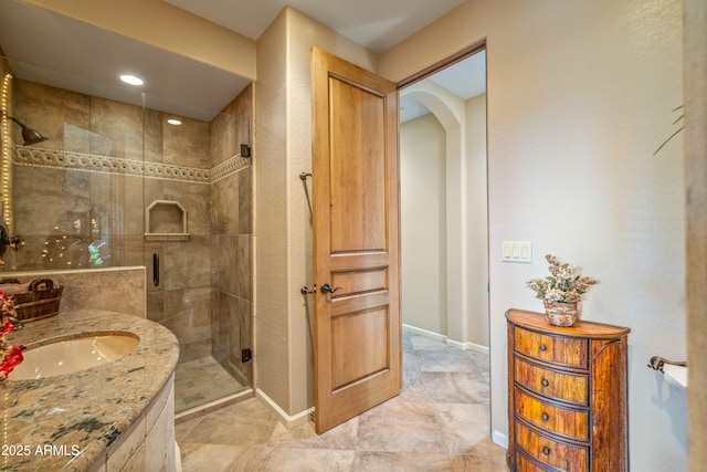 bathroom with vanity and a shower with shower door