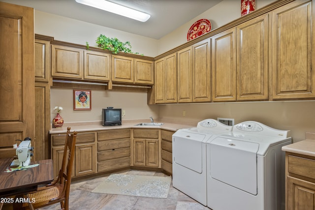 laundry room with washer and dryer, cabinets, light tile patterned floors, and sink