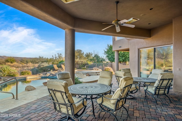 view of patio with ceiling fan and a fenced in pool