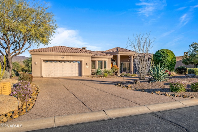 mediterranean / spanish-style home with a garage