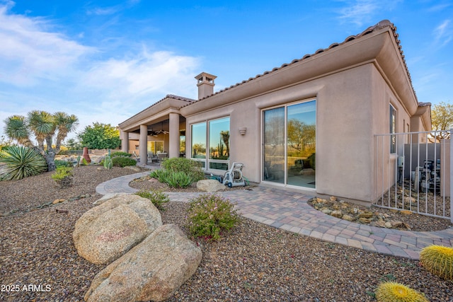 back of house with a patio and ceiling fan