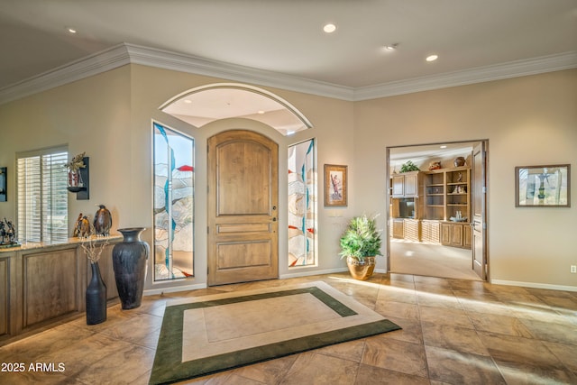 foyer entrance featuring ornamental molding