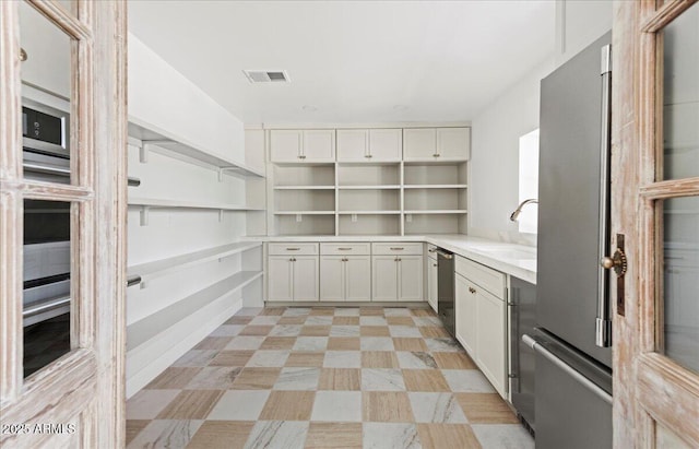 10755 E Cholla Ln, Scottsdale, AZ 85259 - kitchen with open shelves, a sink, stainless steel appliances, and light countertops