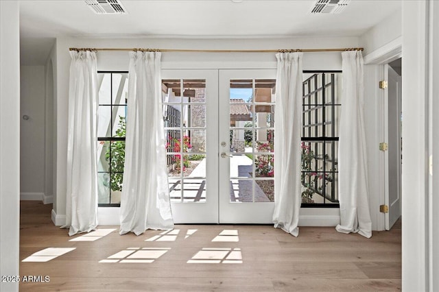 10755 E Cholla Ln, Scottsdale, AZ 85259 - entryway featuring french doors, healthy amount of natural light, and wood finished floors